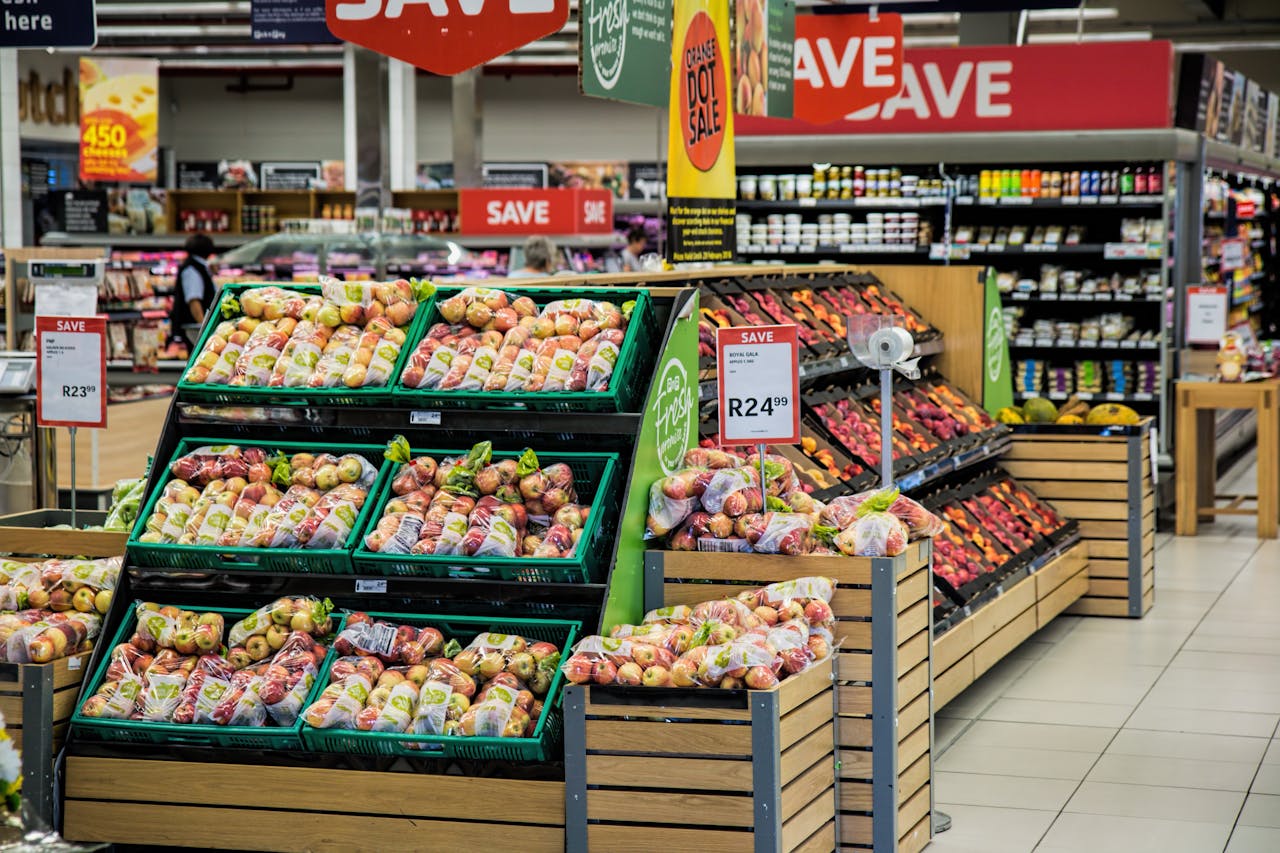 Home Colorful produce aisle in a supermarket showcasing fresh apples with discount signage.